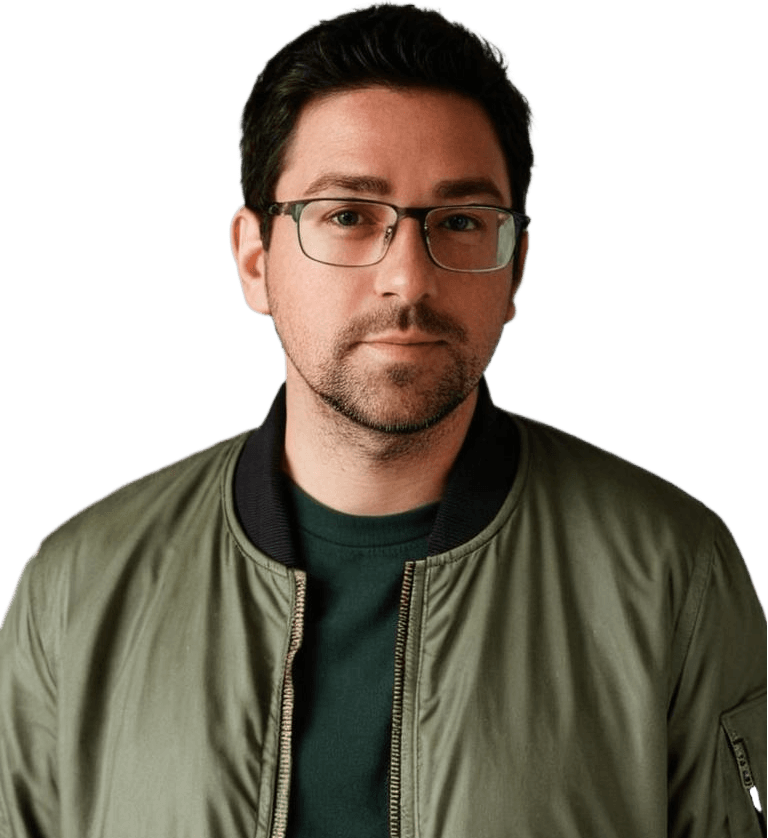 Mike from FawkesFocus.com with glasses in a casual green jacket and dark shirt posing against a neutral background. Professional appearance suitable for business or tech settings.